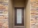 Inviting front door surrounded by detailed stonework at 8908 Azalea Sands Ln, Davenport, FL 33896