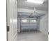 Clean and spacious two-car garage featuring an automatic door opener and ample lighting at 8908 Azalea Sands Ln, Davenport, FL 33896