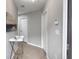 Neutral-toned hallway featuring tile flooring and crisp white doors at 8908 Azalea Sands Ln, Davenport, FL 33896