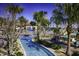 Resort-style community lazy river, surrounded by lush landscaping and palm trees at 8908 Azalea Sands Ln, Davenport, FL 33896