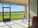Outdoor patio featuring seating and views of the golf course at 8908 Azalea Sands Ln, Davenport, FL 33896