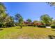 Expansive backyard with lush green lawn, mature trees, and well-maintained landscaping at 160 Archers Pt., Longwood, FL 32779