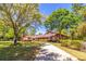 Charming home featuring a long driveway, mature trees, and well-maintained landscaping at 160 Archers Pt., Longwood, FL 32779