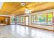 Large living room features bright windows, light tiling, and a view of the pool at 160 Archers Pt., Longwood, FL 32779