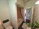 Neutral bathroom featuring a tub with a floral curtain and dark tile flooring at 1000 Elmwood St, Orlando, FL 32801