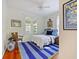 Bright bedroom features white walls, colorful rug, and a twin bed with blue accents at 1000 Elmwood St, Orlando, FL 32801