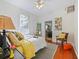 Bright bedroom with hard wood floors, yellow accents and a ceiling fan at 1000 Elmwood St, Orlando, FL 32801