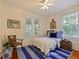 Bright bedroom features white walls, colorful rug, and a twin bed with blue accents at 1000 Elmwood St, Orlando, FL 32801