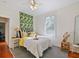 Bright bedroom with hard wood floors, yellow accents and a ceiling fan at 1000 Elmwood St, Orlando, FL 32801