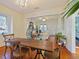 Open-concept dining area with wood floors, a large table, and views into the living room at 1000 Elmwood St, Orlando, FL 32801