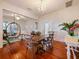 Open-concept dining area with wood floors, a large table, and views into the living room at 1000 Elmwood St, Orlando, FL 32801