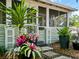 Close up of the front porch featuring colorful potted plants and stylish architectural details and front door at 1000 Elmwood St, Orlando, FL 32801