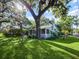 This charming home features lush landscaping and a cozy screened in porch at 1000 Elmwood St, Orlando, FL 32801
