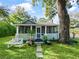 Charming home featuring a beautifully landscaped front yard, stone path and an inviting screened in porch at 1000 Elmwood St, Orlando, FL 32801