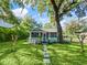 Charming home featuring a beautifully landscaped front yard, stone path and an inviting screened in porch at 1000 Elmwood St, Orlando, FL 32801