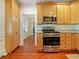 Kitchen with granite countertops, stainless steel appliances, and wood cabinetry at 1000 Elmwood St, Orlando, FL 32801