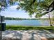 Scenic view of a tranquil lake framed by lush greenery and mature trees on a bright day at 1000 Elmwood St, Orlando, FL 32801