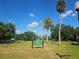 A scenic view of Cherokee Park, featuring lush green lawns, mature trees, and a clear blue sky in Orlando at 1000 Elmwood St, Orlando, FL 32801