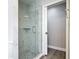 Glass shower with marble-look tile work and decorative shelf in a bright and modern bath at 101 Sandpebble Pl, Sanford, FL 32771