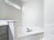 Marble-look tiled tub and gray vanity in a bright, neutral bathroom at 101 Sandpebble Pl, Sanford, FL 32771
