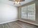 Cozy bedroom with wood-look flooring, a ceiling fan, and a bright window view at 101 Sandpebble Pl, Sanford, FL 32771