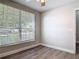 Comfortable bedroom features wood-look flooring, a ceiling fan, and bright natural light at 101 Sandpebble Pl, Sanford, FL 32771