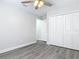 Neutral bedroom featuring wood-look flooring, ceiling fan and a spacious closet at 101 Sandpebble Pl, Sanford, FL 32771