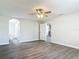 A bedroom with wood-look flooring featuring doorways to bathroom and closet areas at 101 Sandpebble Pl, Sanford, FL 32771