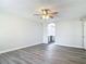 A spacious bedroom featuring a ceiling fan and gray wood-look flooring at 101 Sandpebble Pl, Sanford, FL 32771