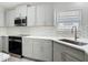 Updated kitchen featuring stainless steel appliances, gray cabinets, and bright countertops at 101 Sandpebble Pl, Sanford, FL 32771
