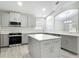 Well-equipped kitchen boasts gray cabinets, marble countertops, and stainless steel appliances at 101 Sandpebble Pl, Sanford, FL 32771