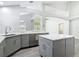 Stylish kitchen featuring gray cabinets, marble countertops, stainless steel appliances and tile backsplash at 101 Sandpebble Pl, Sanford, FL 32771