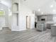 Open-concept layout featuring a modern kitchen with gray cabinets, island, and adjacent living space at 101 Sandpebble Pl, Sanford, FL 32771