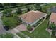 A gorgeous aerial view of the home showcasing a lush landscape, brick driveway, and a gray two-car garage at 12184 Aztec Rose Ln, Orlando, FL 32827