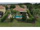 Aerial view of the property features a private pool, lush landscaping, and a well-maintained backyard at 12184 Aztec Rose Ln, Orlando, FL 32827