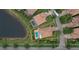 Stunning aerial view showcases the property's private pool, backyard, and serene lake setting at 12184 Aztec Rose Ln, Orlando, FL 32827