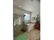 The bright bathroom features a glass shower, soaking tub, and granite countertops at 12184 Aztec Rose Ln, Orlando, FL 32827