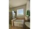 The bright bathroom features a glass shower, soaking tub, and granite countertops at 12184 Aztec Rose Ln, Orlando, FL 32827