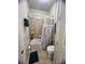 Cozy bathroom featuring a shower-tub combination with tiled walls and a marine-themed shower curtain at 12184 Aztec Rose Ln, Orlando, FL 32827