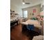Bright bedroom with hardwood floors, large window, and a desk area at 12184 Aztec Rose Ln, Orlando, FL 32827