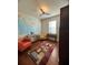 Bright room with a world map, stylish furniture, and a modern ceiling fan, creating a welcoming space at 12184 Aztec Rose Ln, Orlando, FL 32827