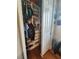 Walk-in closet with custom shelving, hanging rods, organized storage, and hardwood floors for functionality at 12184 Aztec Rose Ln, Orlando, FL 32827