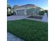 Beautiful home exterior features a lush lawn and well-maintained landscaping at 12184 Aztec Rose Ln, Orlando, FL 32827