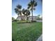 Attractive home with palm trees and manicured lawn, perfect for curb appeal at 12184 Aztec Rose Ln, Orlando, FL 32827