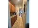 Hallway with tile flooring, wall cabinets, and a view into the dining and kitchen area at 12184 Aztec Rose Ln, Orlando, FL 32827