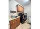 Laundry room with sink, cabinets, and modern washer and dryer at 12184 Aztec Rose Ln, Orlando, FL 32827