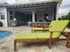 Relaxing poolside patio with a built in barbeque and lush green lounge chairs perfect for warm days at 12184 Aztec Rose Ln, Orlando, FL 32827