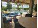 Inviting covered patio area with comfortable seating, outdoor dining space, and a lovely pool view at 12184 Aztec Rose Ln, Orlando, FL 32827