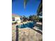 Beautiful kidney shaped pool and patio with views of the lush greenery and clear blue sky at 12184 Aztec Rose Ln, Orlando, FL 32827