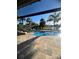 Backyard view of beautiful pool, stone patio and lounge chairs with a view of the lake at 12184 Aztec Rose Ln, Orlando, FL 32827